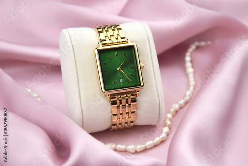 Closeup minimal fashion wristwatch for women on pink background.