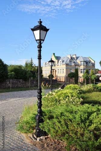 Summer landscape. Lighting lanterns along the pedestrian path.

