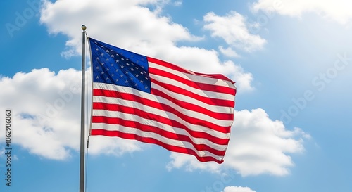 American Flag Waving Proudly Against a Blue Sky with Clouds.