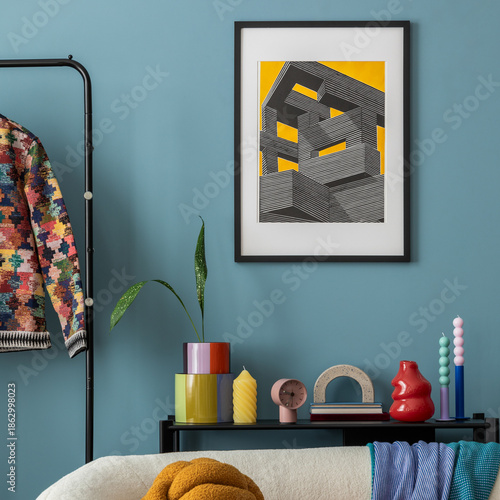 Interior desgin of modern living room interior with mock up poster frame, colorful decorations and accessories, plants, sofa, coffee table. Blue wall. Home decor. Template