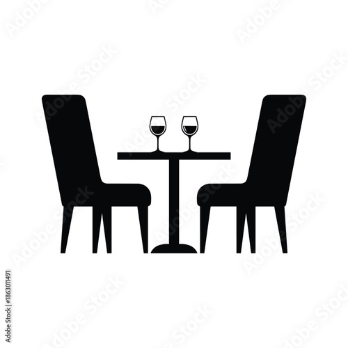 Two wine glasses on a table with two chairs