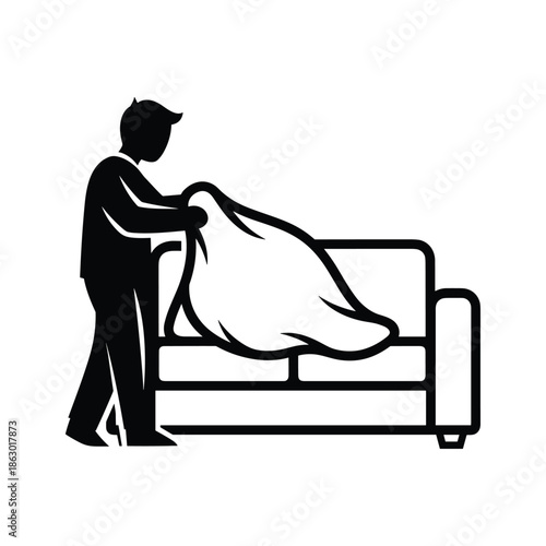 Man covering couch with blanket
