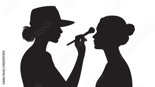 Makeup Artist Applying Cosmetics to Womans Face in Silhouette