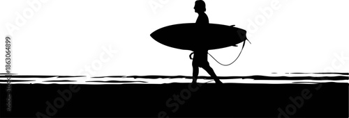 Surfer walking along the beach