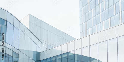 Modern glass wall background with high building design show clean line and futuristic urban business innovation concept in bright daylight sky