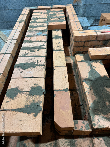 Fresh brickwork of a heating stove bench. Overlap of the benchs smoke channels.