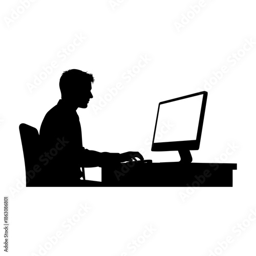 Silhouette of a man working diligently at a computer desk.
