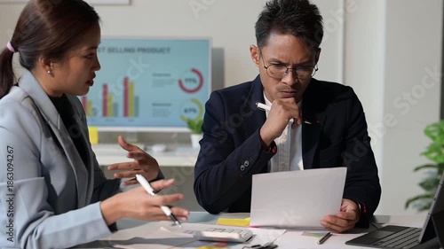 Stressed business people arguing over financial report in office meeting