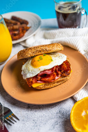 Breakfast sandwich with bacon egg and cheese on whole grain bread