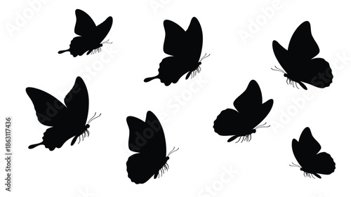 A collection of black butterflies in flight a striking silhouette