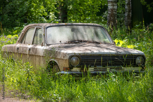 GAZ-24-10 Volga in the thick grass.  An abandoned Soviet car of the middle class produced by the Gorky Automobile Plant