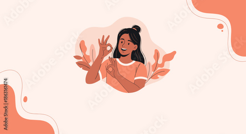Cheerful woman making the okay hand gesture while surrounded by abstract orange shapes and delicate plant leaves.