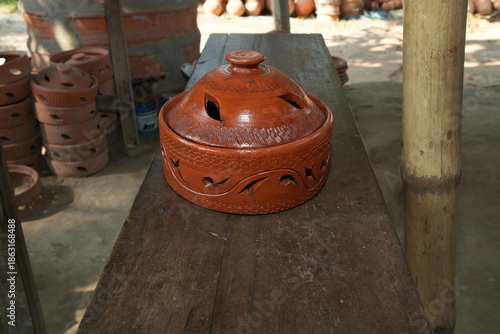 Handcrafted Terracotta Pot with Decorative Cut-outs and Lid