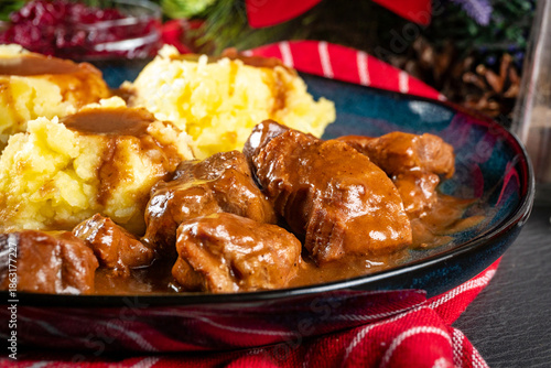 Beef goulash with mashed potatoes and grated beetroot.