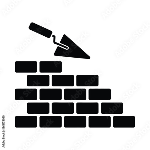 Black and white illustration of a trowel over a brick wall