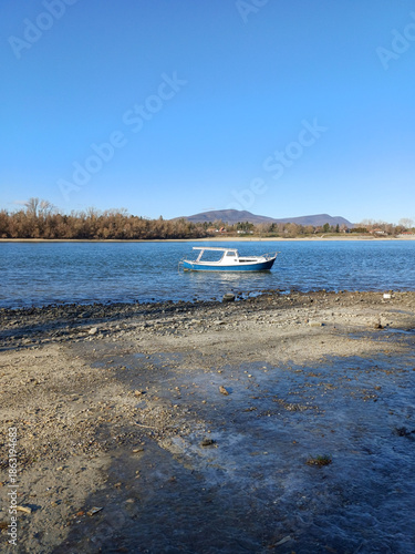 Low Water Riverbank With Boats