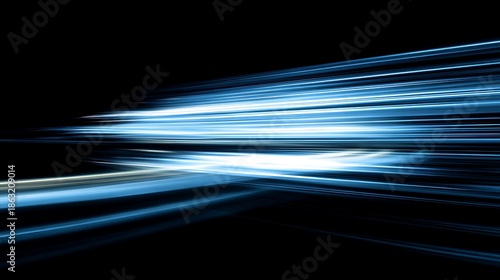 Dynamic abstract image featuring bright blue light streaks against a dark background, suggesting motion