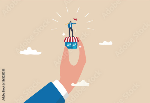 Small business idea, successful entrepreneur with small retail shop or storefront, shop owner or merchandise opportunity concept, success businessman holding winner flag on small store in giant hand