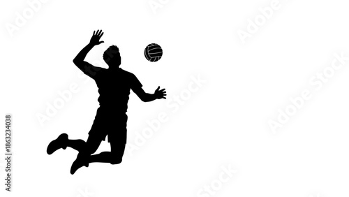 Silhouette of a male volleyball player jumping to spike the ball during a game.
