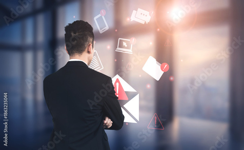 Bilde på lerret A businessman dressed in a suit stands in a modern office, observing digital notifications and email alerts amidst a sleek workspace featuring natural light