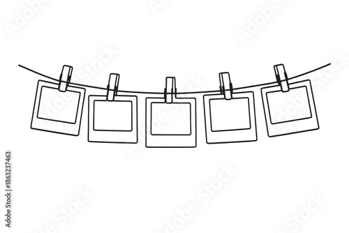 Five empty picture frames hanging on a wire with clothespins