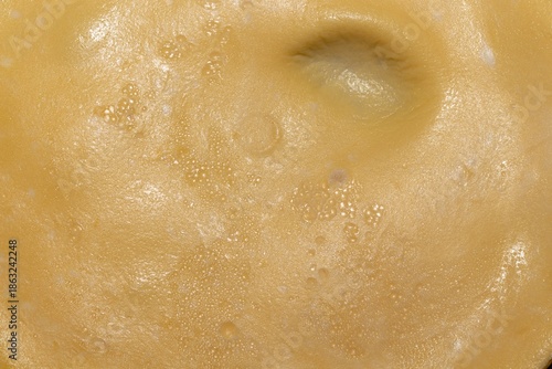 Tableau sur toile A close up view of a golden brown surface with small bubbles and a slight indent