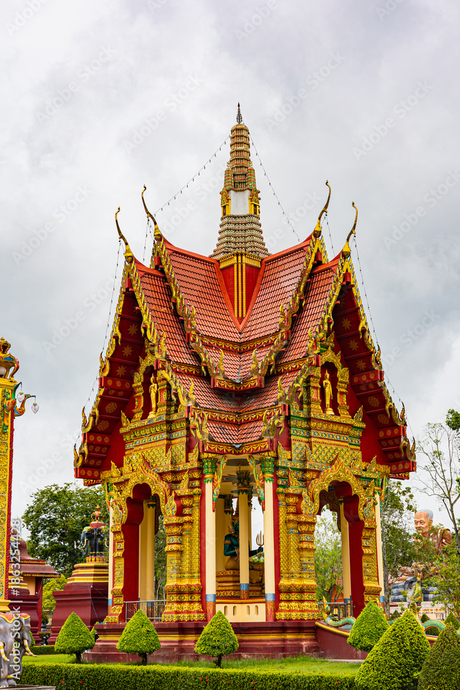 Fototapeta premium Intricately Decorated Thai Temple With Red Roofs, Gold Ornaments, And Elegant Spire Tower Zen Architecture. Wat Bang Thong in Krabi, Thailand