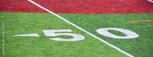 The 50-yard-line of an american football field with artificial turf