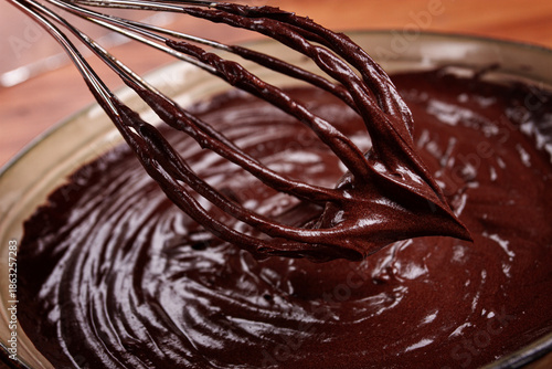 a bowl of chocolate dough, a whisk for whipping, baking, structure and consistency, homemade, top view, no people,