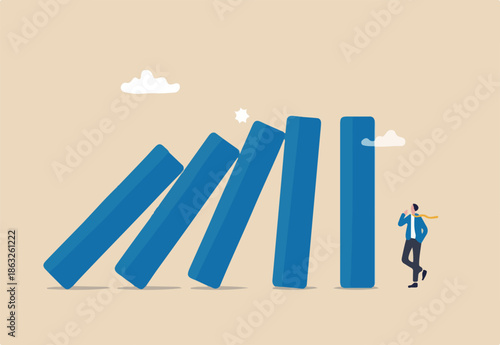 Risk management, uncertainty or unknown threat causing business failure, economic crisis, danger or problem, security and safety concept, courage businessman thinking look at collapsing domino effect.