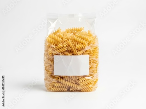 Clear plastic bag filled with spiral pasta against a plain white background 
