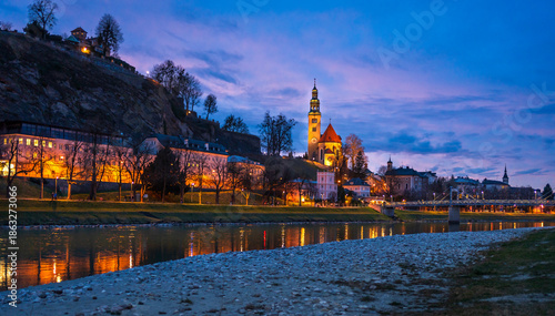 Evening view of Salzac River, Salzburg Old town, church in Austria.