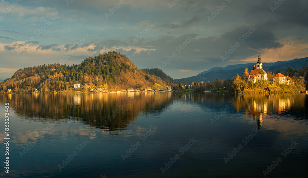 Obraz premium Church and bell tower of Bled Island in Lake Bled in Slovenia during sunset. 