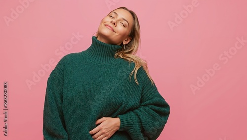Woman Smiles While Embracing Herself in a Studio With Pink Background During ...