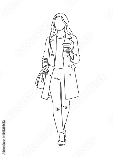 Young woman walking while holding coffee and wearing a coat  