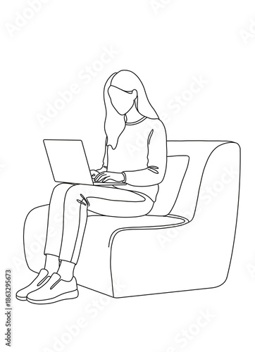 Young woman working on laptop while sitting on modern chair  