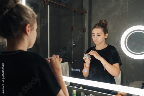 Woman applying moisturizer during her daily skincare routine