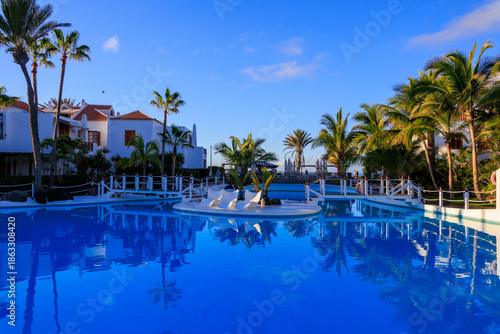 Hotel resort panorama with swimming pool, bridge and palm trees in Playa de las Americas, Tenerife
