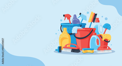 Banner with a collection of colorful cleaning supplies and tools for household chores on a light blue background with copy space.