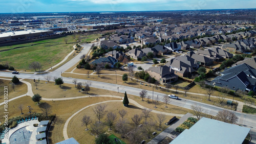Fotografi Central park with splash pad, curved walkways, open lawns sits beside residentia