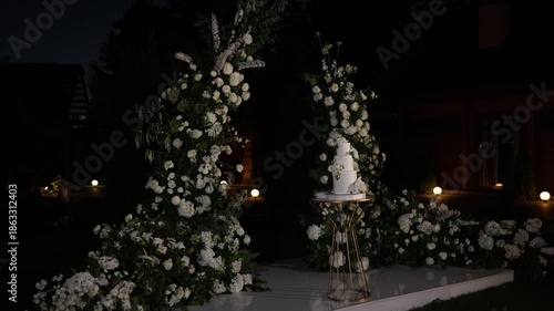 White wedding cake standing on a table