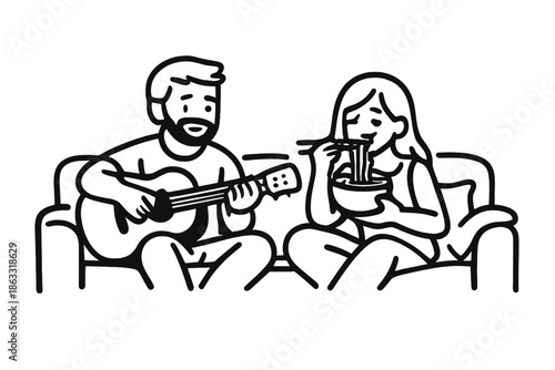 Couple relaxing on couch: man playing guitar, woman eating noodles