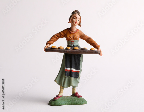 A girl selling pastries figurine