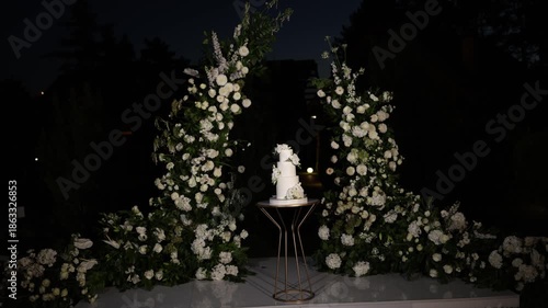 White wedding cake standing on a table
