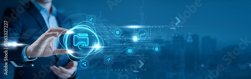Photos Businessman holding a cloud backup symbol in his hand data protection, disaster