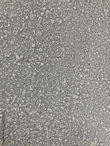 Grunge grey asphalt texture with natural cracks and rough surface details