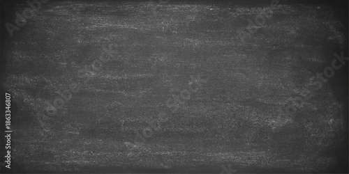 Old grunge chalkboard background with a rough black texture and a blank blackboard surface with an alpha channel featuring vintage gray paper patterns and dirty white chalk on a dark wall backdrop. 