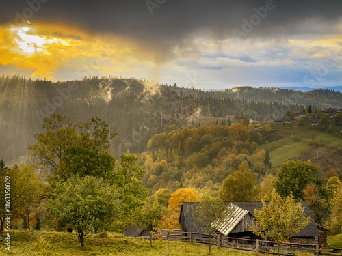 Sunny Autumn Carpathians with Puffy White During The Sunset