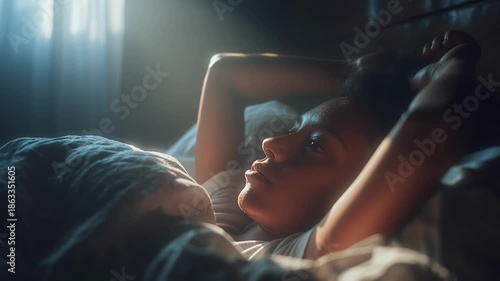 Close-up of a young woman sleeping peacefully in a bed with white linens, as soft morning sunlight filters through blinds, creating a serene and cozy atmosphere