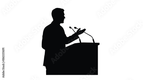 A speaker at a podium delivering a presentation dark and dramatic silhouette